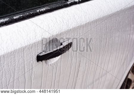 De-icing Car Doors And Locks. A Close-up Of A Frozen Lock Of A Car Door After Freezing Rain, Ice Sto