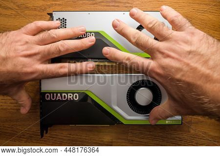 Paris, France - Mar 28, 2019: Senior And Young Engineer Hands Pov Holding Looking At Two New Gpu Vid