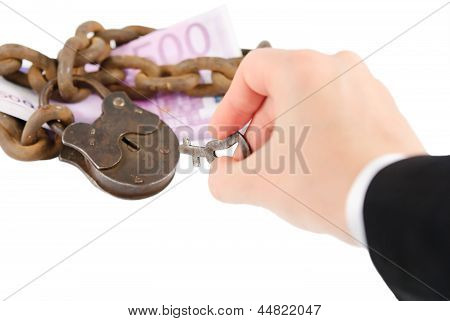 Money Security Concept - Hand With Key Try To Unlock Money