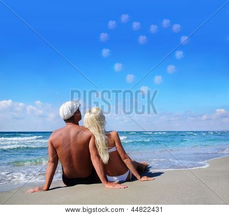 Love Concept - Couple On Sea Beach Look At Cloudy Heart