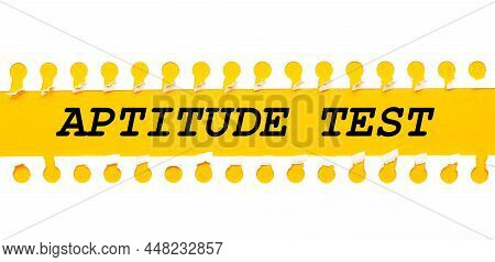 Torn Paper Strip On Yellow Background With Text Aptitude Test