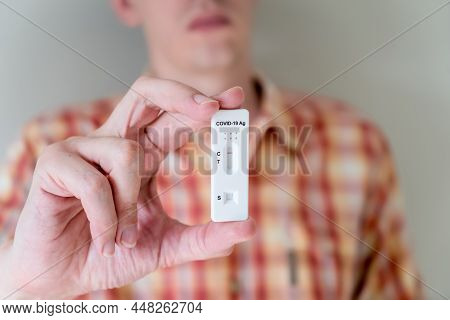 Man Holding Covid-19 Rapid Antigen Test Cassette With Negative Result Of Rapid Diagnostic Test. Self