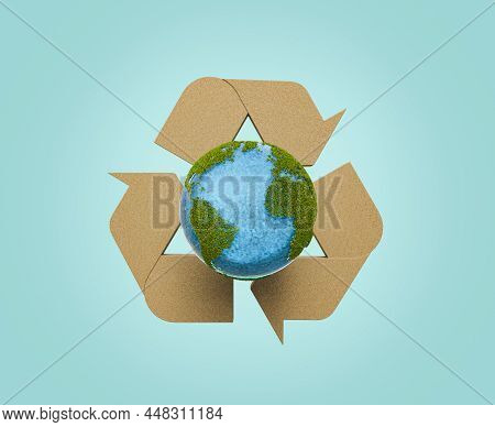 Planet Earth With Vegetation And Wood Recycling Symbol On The Back. Concept Of Sustainable Resources