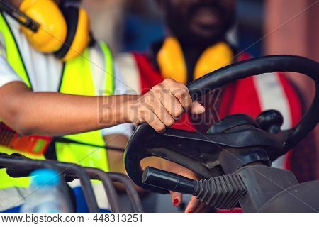 Two African American Male And Female Worker In Uniform And Helmet Driving And Operating On Diesel Co