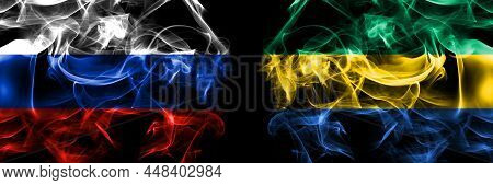 Russia, Russian Vs Gabon, Gabonese, Gabonian Flags. Smoke Flag Placed Side By Side Isolated On Black