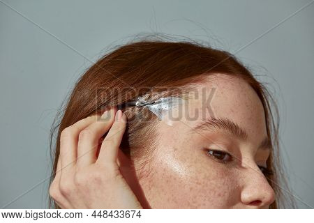 Fox Eyes Effect. Close Up Of Redhead Young Girl Using Instant Face Lift Band Tape For Slightly Uptur