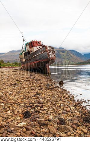 The Old Fishing Boat On The Shingled Shoreline Of Loch Linnhe Near Fort William , Scotland Highland,