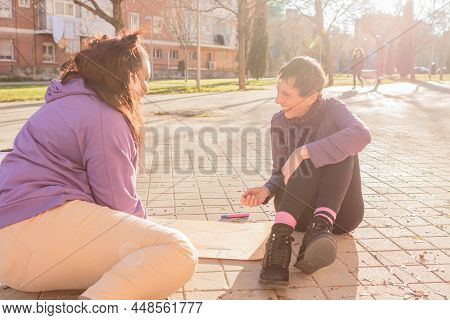 2 Multicultural Woman Prepare Banners For 8 March Feminism Protest