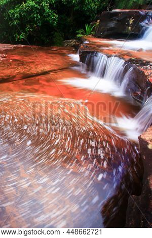 Pure Streamlet Falling On Layers Of Sandstone Pool, Abstract Stream With Froth On Surface Of The Poo