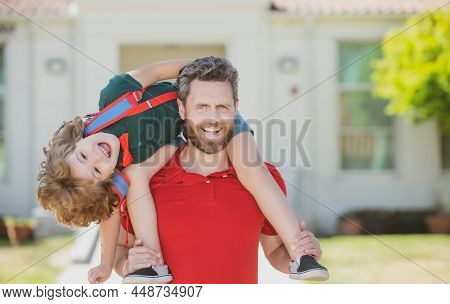 Father Giving Son Piggyback Ride After Come Back From School. School, Family, Education And Outdoor 