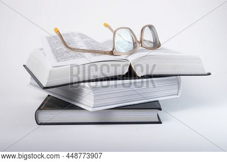 Glasses At Books Stack. Education, Preparing For Exams, Information Search Concept. Books, Codes Or 