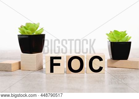 Foc. Abbreviation Of Free Of Charge. On Wood Background
