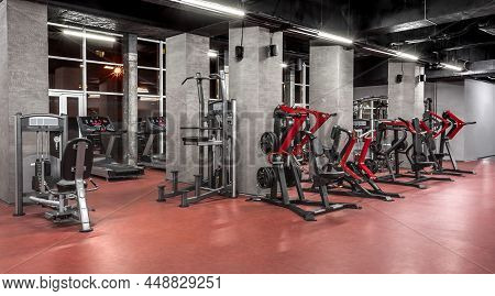 Special Contemporary Equipment For Physical Training In Spacious, Well Lit, Empty Gym Interior. Exer