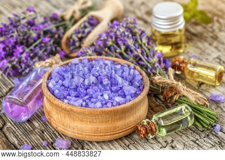 Lavender's Spa Products With Dried Lavender Flowers On A Wooden Table. Flat Lay Bath Salt And Massag