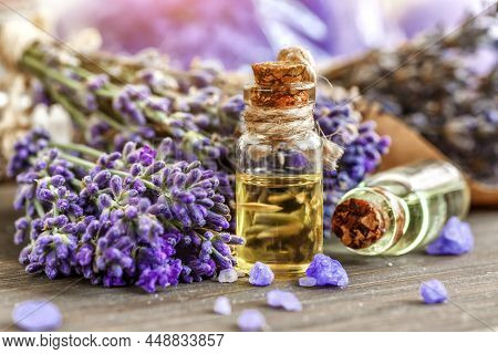 Lavender's Spa Products With Dried Lavender Flowers On A Wooden Table. Flat Lay Bath Salt And Massag