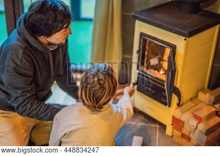 Dad And Son Spend Time By The Fireplace In Glamping. Rest In The Mountains In Glamping. Cozy Firepla