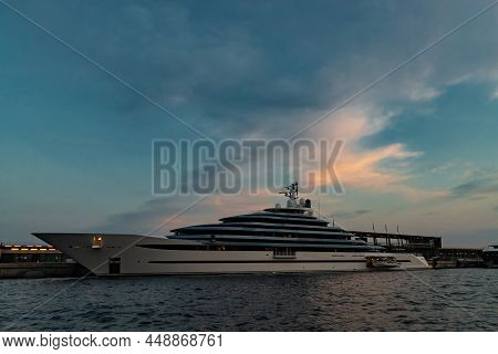 The Left Side Of Huge Yacht In Port Of Monaco At Sunset, Glossy Board Of The Motor Boat, The Chrome 