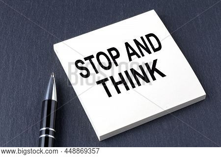Stop And Think Text On Sticker With Pen On The Black Background