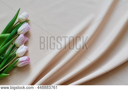 Spring Bouquet Of Pink Tulips On Beige Fabric With Folds