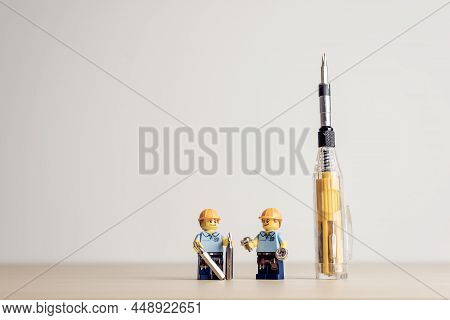 Construction Workers With Screwdriver. Illustrative Editorial. January 09, 2022