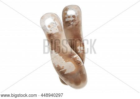 Two Old, Shabby Orthopedic Insoles Isolated On White Background. Dirty Leather Insoles. Worn Out Thi