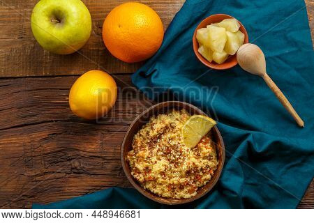 Couscous Masfouf With Dried Fruits And Nuts In A Plate On A Blue Napkin On A Wooden Table Next To A 
