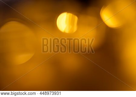 Many Blurred Small Electric Bulbs On A Wall. Yellow Blurred Lights. Wall Of Christmas Lights