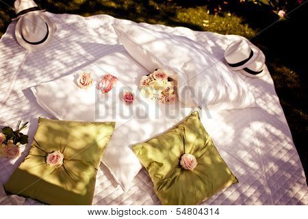 Blanket and pillows decorated with roses