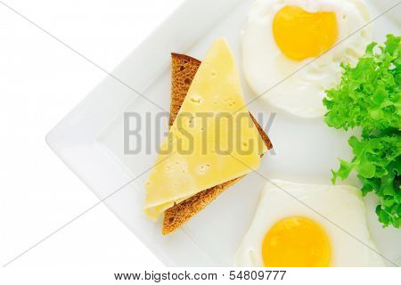 two fried eggs with salad bread and cheese