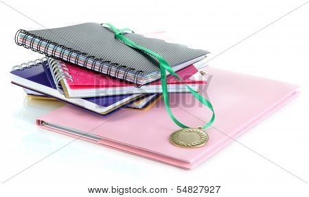Medal for achievement in education and notebooks isolated on white