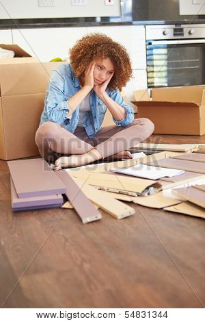 Frustrated Woman Putting Together Self Assembly Furniture