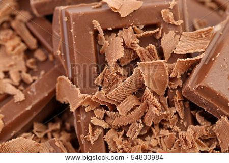 Tasty morsel and slices of milk chocolate.
