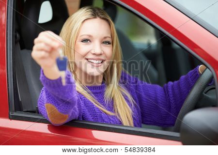 Teenage Girl Standing Next To Car Holding Key