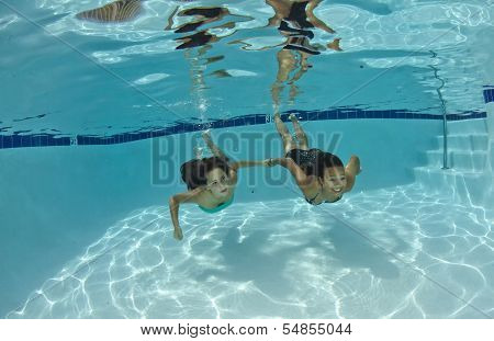 Friends Swimming Underwater