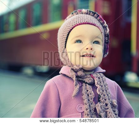 Little cute girl ready to vacation on railway station, baby girl fashion model go on travels, toned
