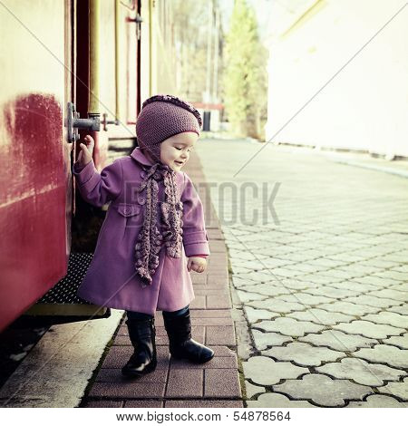 Little cute girl ready to vacation on railway station, baby girl fashion model go on travels, toned
