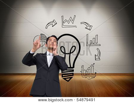 Composite image of thouhgtful asian businessman pointing