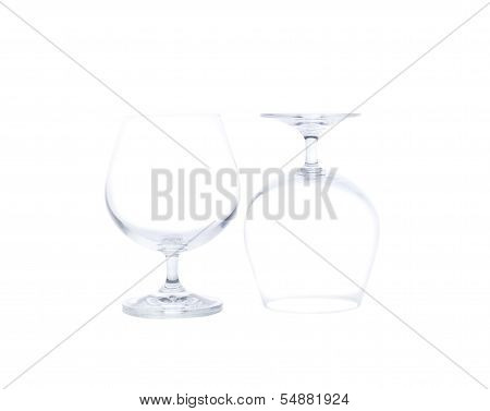 Two empty glasses of brandy isolated on white