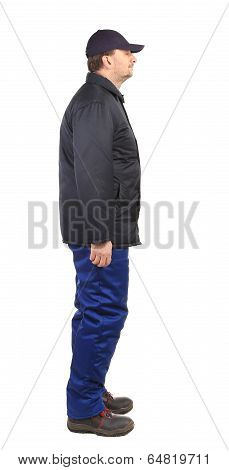 Worker in winter workwear. Side view.
