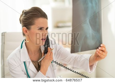 Medical Doctor Woman Looking On Fluorography And Talking Phone
