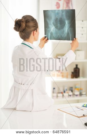 Medical Doctor Woman Looking On Fluorography. Rear View