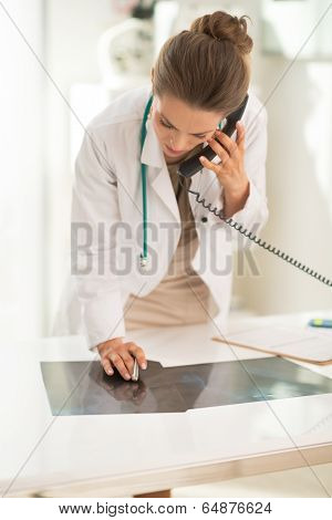 Medical Doctor Woman With Fluorography Talking Phone In Office