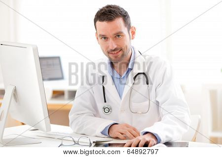 Portrait Of A Young Smiling Doctor In His Office