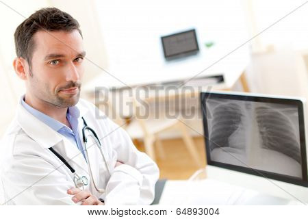 Portrait Of A Young Doctor Analysing A Radiography