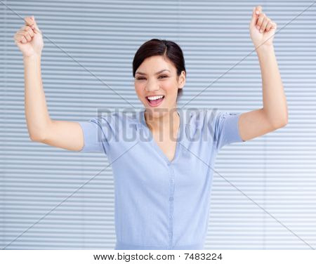 Successful Businesswoman Punching The Air In Celebration