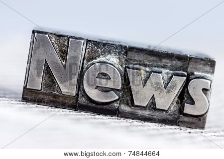 the word news written with lead letters. symbol photo for newsletters, newspapers and information