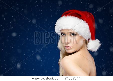 Pretty woman in Christmas cap,blue background