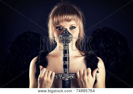 woman with black wings and sword hilt