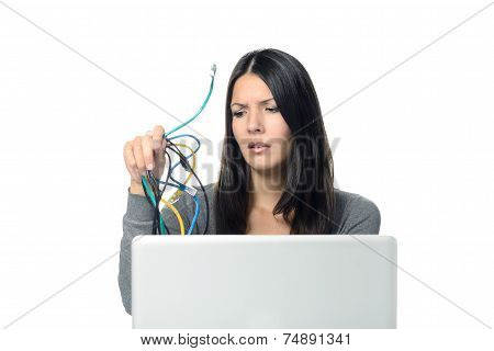 Woman Holding Cables In Her  Hand While Using Laptop