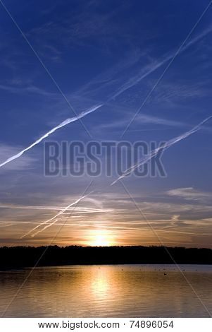 The sun shining on horizon behind cloud